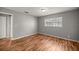 This bedroom features hardwood floors, neutral walls, and a window offering natural light at 15044 Sw 35Th Avenue Rd, Ocala, FL 34473