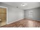 Neutral bedroom with wood-look flooring and an attached bathroom featuring a tiled shower at 15044 Sw 35Th Avenue Rd, Ocala, FL 34473