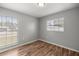 This bedroom offers hardwood floors and two windows that bring in plenty of light at 15044 Sw 35Th Avenue Rd, Ocala, FL 34473