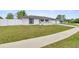 Charming single-story home featuring a manicured lawn and a classic color scheme at 15044 Sw 35Th Avenue Rd, Ocala, FL 34473