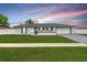 Charming single-story home featuring a manicured lawn and a classic color scheme at 15044 Sw 35Th Avenue Rd, Ocala, FL 34473