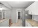 Kitchen with stainless steel fridge that leads to the living room or laundry room at 15044 Sw 35Th Avenue Rd, Ocala, FL 34473