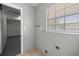 Laundry room with window to the right with tile flooring and gray painted walls at 15044 Sw 35Th Avenue Rd, Ocala, FL 34473