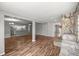 Open-concept living room with hardwood floors, a stone fireplace, and modern lighting at 15044 Sw 35Th Avenue Rd, Ocala, FL 34473