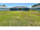 Spacious backyard, showcasing a well-maintained lawn and the home's blue exterior siding at 15317 Sw 65Th Terrace Rd, Ocala, FL 34473