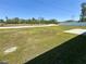 Large, grassy backyard featuring a bright green lawn and a partial view of the surrounding neighborhood at 15317 Sw 65Th Terrace Rd, Ocala, FL 34473