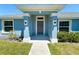 Entrance featuring a gray front door with sidelights and pillars, enhancing curb appeal and style at 15317 Sw 65Th Terrace Rd, Ocala, FL 34473