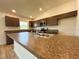 Modern kitchen features granite countertops, stainless steel appliances and wood cabinets at 15317 Sw 65Th Terrace Rd, Ocala, FL 34473