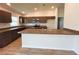 New kitchen features granite countertops, stainless steel appliances, ample storage and eat-in island at 15317 Sw 65Th Terrace Rd, Ocala, FL 34473