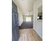 An entryway with new wood flooring leads to an open living room with vaulted ceiling and sliding glass doors at 15317 Sw 65Th Terrace Rd, Ocala, FL 34473
