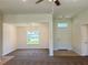 Open-concept living space features natural light, ceiling fan, and leads into dining and entry at 15317 Sw 65Th Terrace Rd, Ocala, FL 34473