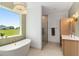 Well-lit bathroom with a soaking tub, glass enclosed shower, and vanity at 1784 Nw 85Th Loop, Ocala, FL 34475