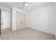 Clean bedroom with ceiling fan, neutral walls and carpeting, and double door closet at 1784 Nw 85Th Loop, Ocala, FL 34475