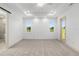 Bright bedroom featuring a tray ceiling, recessed lights, and access to a private bath at 1784 Nw 85Th Loop, Ocala, FL 34475