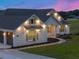 Well-lit home showcasing its appealing facade, neat landscaping, and convenient garage access at 1784 Nw 85Th Loop, Ocala, FL 34475
