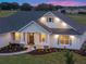 Well-lit home exterior with manicured landscaping and a welcoming front entrance at twilight at 1784 Nw 85Th Loop, Ocala, FL 34475