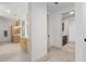 Hallway with multiple bathroom entrances featuring a consistent and modern design aesthetic at 1784 Nw 85Th Loop, Ocala, FL 34475