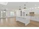 Bright kitchen with white cabinets, island, pendant lighting, and open layout perfect for modern living at 1784 Nw 85Th Loop, Ocala, FL 34475