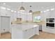 Stylish kitchen featuring white cabinets, a center island, and stainless steel appliances creating a modern cooking space at 1784 Nw 85Th Loop, Ocala, FL 34475