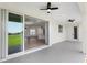 Covered lanai with ceiling fans and views of the green lawn, seamlessly connecting indoor/outdoor living at 1784 Nw 85Th Loop, Ocala, FL 34475