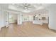 Open-concept living space featuring wood floors, tray ceilings, and an eat-in kitchen at 1784 Nw 85Th Loop, Ocala, FL 34475