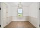 The home office features a large window, wainscoting, and neutral colors at 1784 Nw 85Th Loop, Ocala, FL 34475
