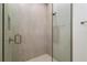 Modern shower with frameless glass enclosure and neutral tile surround at 1784 Nw 85Th Loop, Ocala, FL 34475