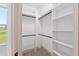 Well-organized walk-in closet with custom shelving and ample storage space at 1784 Nw 85Th Loop, Ocala, FL 34475