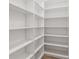 Organized walk-in closet featuring ample shelving creating a functional and tidy storage solution at 1784 Nw 85Th Loop, Ocala, FL 34475
