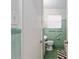 Bathroom with vintage tile, window, toilet and sink at 18027 Se 90Th St, Ocklawaha, FL 32179