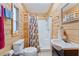 Cozy bathroom with wood paneled walls and shower at 18027 Se 90Th St, Ocklawaha, FL 32179