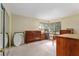 Bedroom with neutral carpet, two corner windows, and a dark wood dresser at 18027 Se 90Th St, Ocklawaha, FL 32179