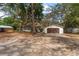 Single story home, detached garage, and sheds with expansive yard and mature trees at 18027 Se 90Th St, Ocklawaha, FL 32179