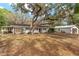 This exterior view shows the house, garage, and lean-to building all on a well-maintained lot at 18027 Se 90Th St, Ocklawaha, FL 32179