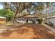Inviting single-story home with a lush front yard and mature trees providing shade at 18027 Se 90Th St, Ocklawaha, FL 32179