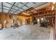 Spacious garage with exposed wood beams and concrete floor at 18027 Se 90Th St, Ocklawaha, FL 32179