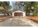 Detached garage with extra storage buildings surrounded by trees at 18027 Se 90Th St, Ocklawaha, FL 32179