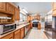 Open kitchen features tile floors, light wood cabinets, stainless steel appliances, and lots of counter space at 18027 Se 90Th St, Ocklawaha, FL 32179