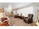 Inviting living room with neutral colors, carpeted floors, and ample natural light at 18027 Se 90Th St, Ocklawaha, FL 32179