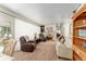 Bright living room with carpet, fireplace, and comfortable furniture at 18027 Se 90Th St, Ocklawaha, FL 32179