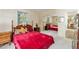 Bright main bedroom features a four-poster bed, neutral carpet, and a mirrored closet at 18027 Se 90Th St, Ocklawaha, FL 32179