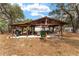 Open-air pavilion with seating, grill and recreational area great for entertaining at 18027 Se 90Th St, Ocklawaha, FL 32179