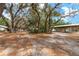Expansive property showcasing the home, carport, and mature trees at 18027 Se 90Th St, Ocklawaha, FL 32179