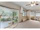 The sunroom showcases sliding doors opening to a patio with lush greenery and landscaping at 18027 Se 90Th St, Ocklawaha, FL 32179