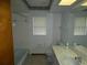 Bathroom featuring a shower-tub combo, toilet, and vanity with integrated sink at 20364 Sw 86Th Loop, Dunnellon, FL 34431