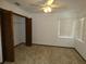 Bedroom with a ceiling fan, closet, two windows, and neutral carpet at 20364 Sw 86Th Loop, Dunnellon, FL 34431