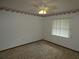 Bedroom with a ceiling fan, window, floral wallpaper border, and carpeted floor at 20364 Sw 86Th Loop, Dunnellon, FL 34431