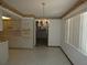 Charming dining area next to the kitchen with a chandelier, floral wallpaper, and tile floors at 20364 Sw 86Th Loop, Dunnellon, FL 34431