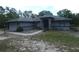Single-story home featuring stone accents, arched windows, and lush surroundings at 20364 Sw 86Th Loop, Dunnellon, FL 34431