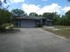 Charming single-story home with a large driveway and well-maintained landscaping at 20364 Sw 86Th Loop, Dunnellon, FL 34431